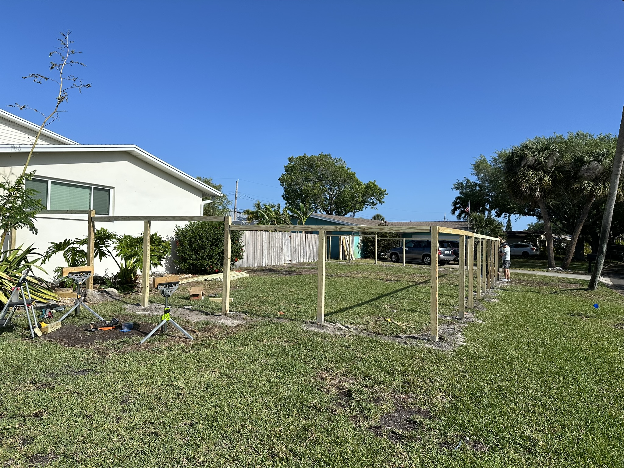 Fence posts and horizontal rails under construction around Drew's Florida yard