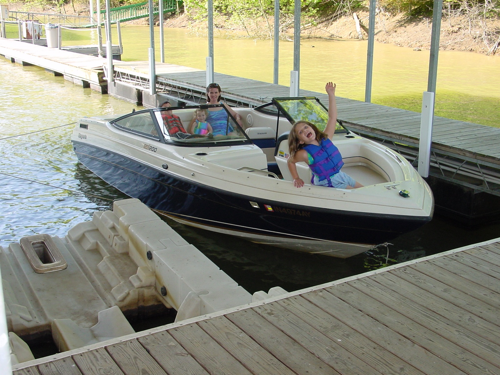 The family in the Bryant bowrider at the dock