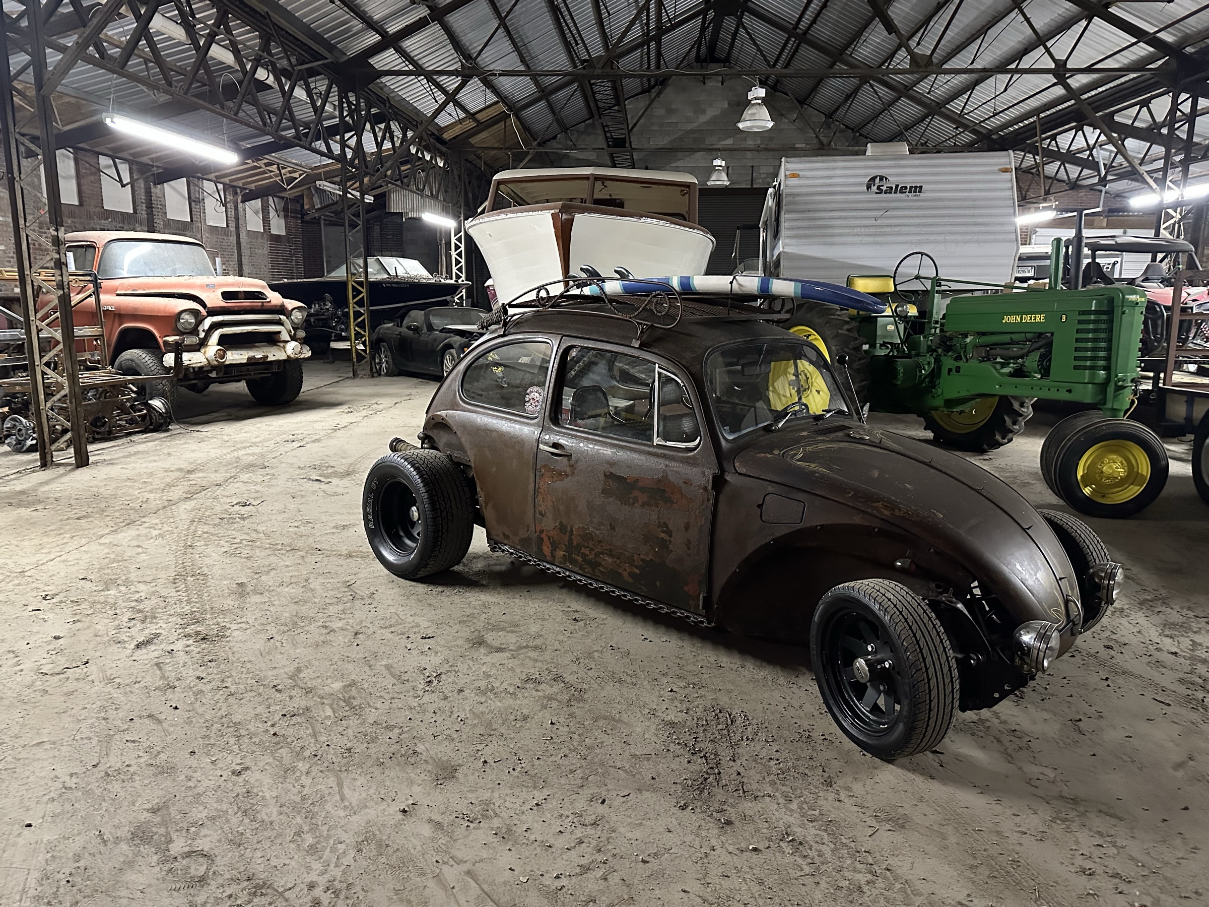 Vehicles, boats, and a tractor in Eric's warehouse
