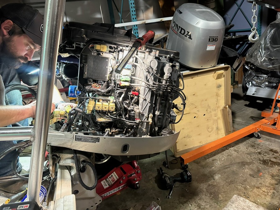 Replacing the powerhead on a Honda 130 outboard motor in the shop