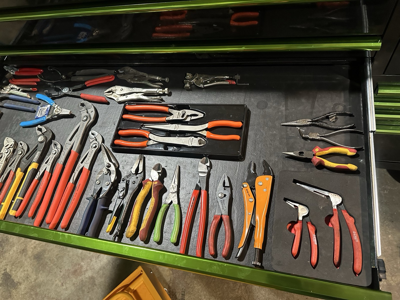 The plier drawer in Eric's Matco toolbox, with many types of pliers and cutters arranged on a liner