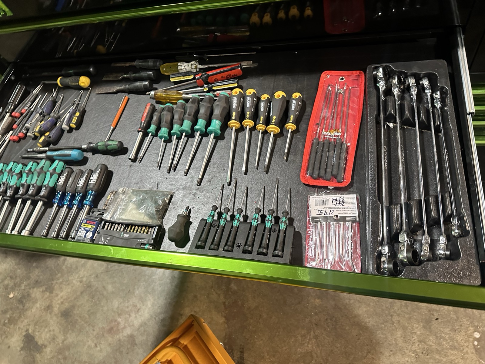 The screwdriver drawer in Eric's Matco toolbox, with drivers and long ratcheting wrenches arranged on a liner