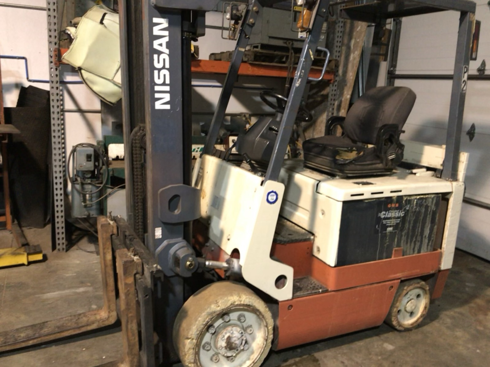 Eric's 6,000-pound Nissan electric forklift inside the shop