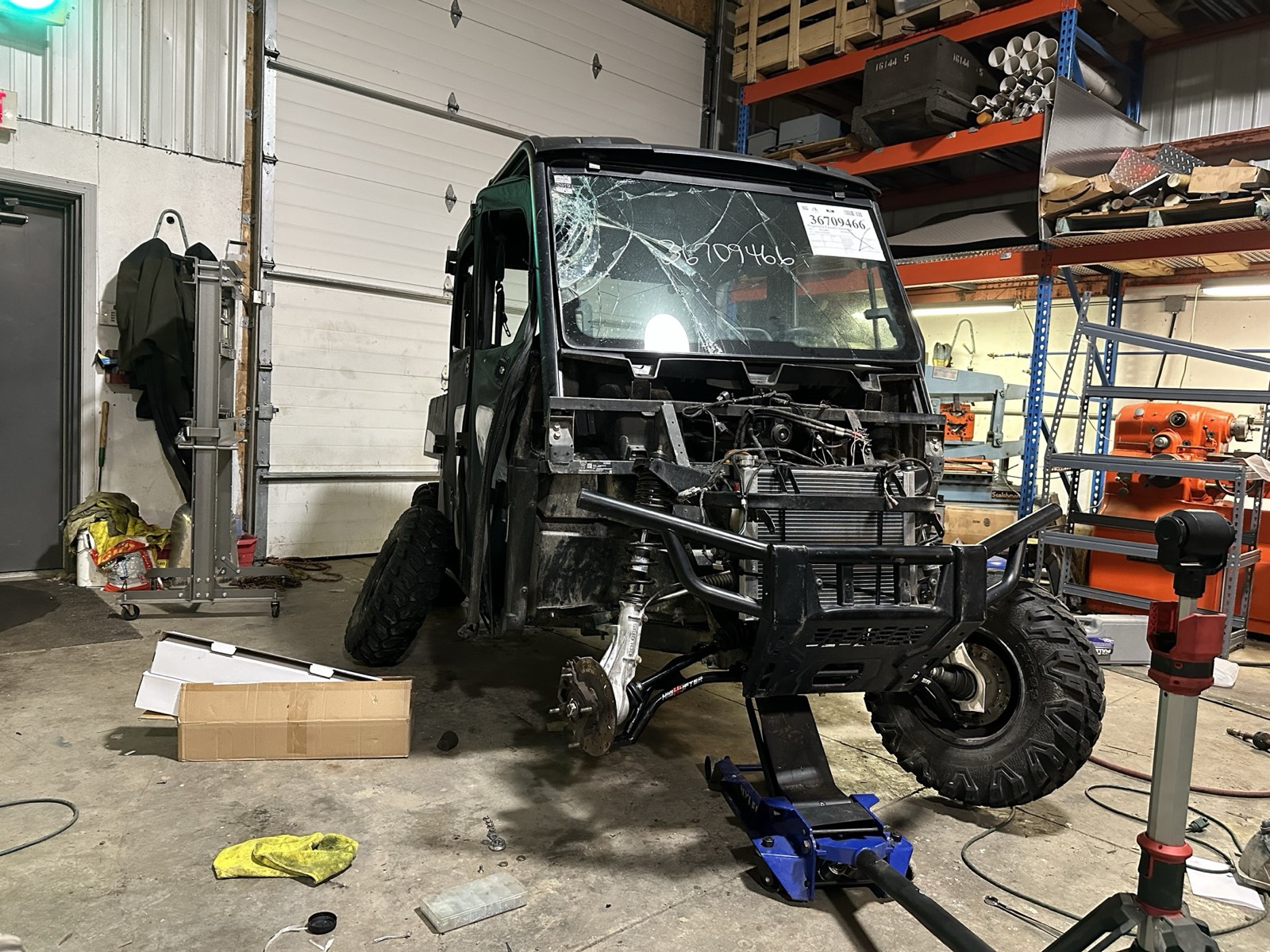 A wrecked Polaris Ranger side-by-side being rebuilt inside Eric's shop