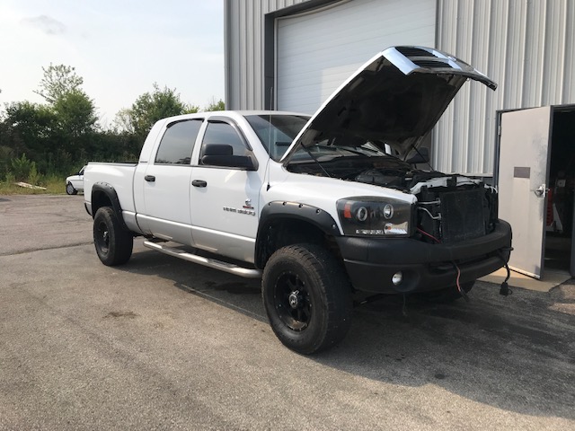 A Dodge truck undergoing a series of repairs